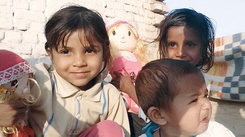 angelina her sister and their cousin pose for a picture with their dolls in chak 2 gd bethlehem photo sarah eleazar express