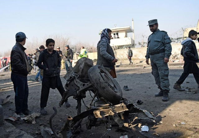 an afghan policeman looks at the wreckage of a car that was used in a suicide car bomb near kabul 039 s international airport on december 28 2015 photo afp an afghan policeman looks at the wreckage of a car that was used in a suicide car bomb near kabul 039 s international airport on december 28 2015 photo afp