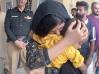 the mother of azan kisses her son after his safe recovery from abductors capturing a moment of relief and affection photo express