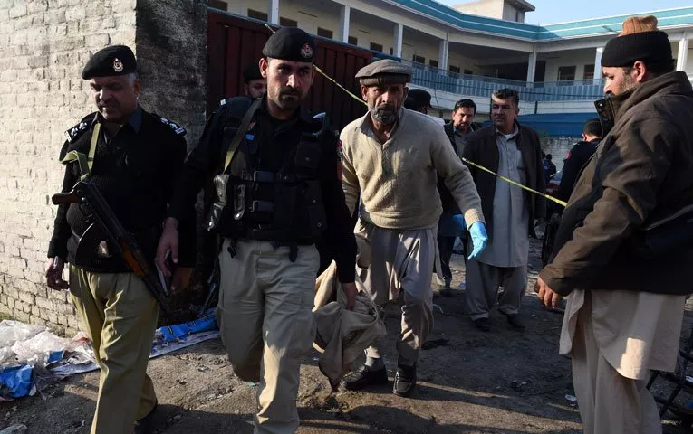 police personnel gather at the bomb blast site in mardan on december 29 2015 photo afp police personnel gather at the bomb blast site in mardan on december 29 2015 photo afp