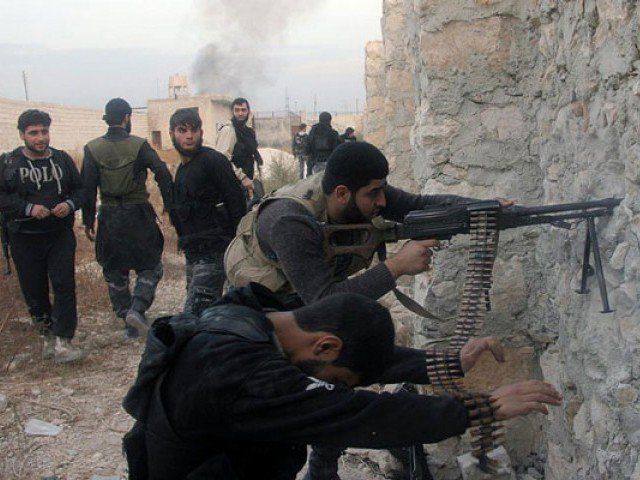 syrian rebel fighters shoot through a hole in a wall towards forces loyal to the regime in 2013 in aleppo photo afp