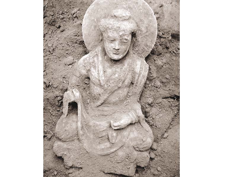 an illegally excavated damaged buddha statue photo hidayat khan