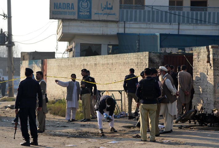 security personnel collect evidence at the bomb blast site in mardan on december 29 2015 photo afp