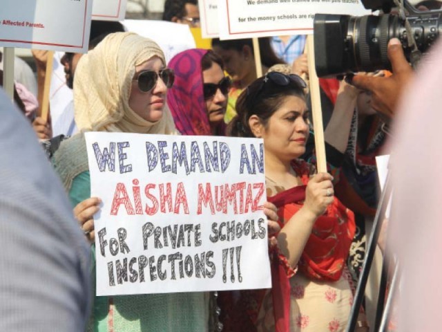 the protesters holding placards against fee hike photo ayesha mir express