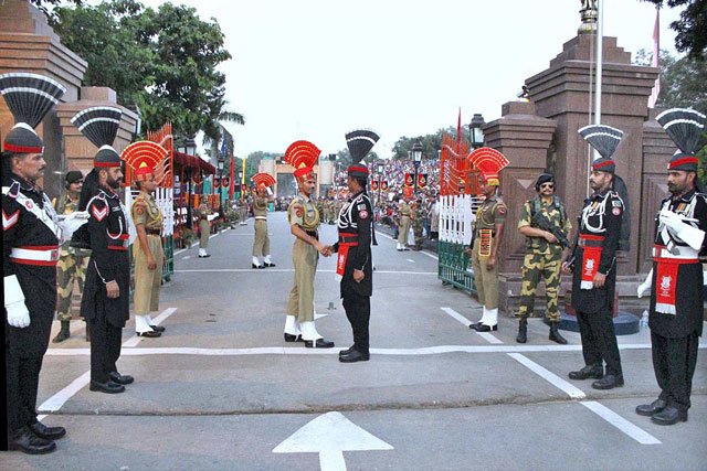 personnel of pakistan and indian rangers shake hands during the flag lowering ceremony at the wagah border on september 13 2015 photo app