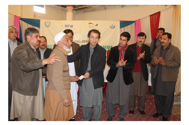 atif khan distributing sehat cards to deserving families at a function which was held in mardan photo fb com shahram khan tarakai