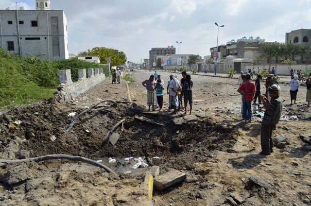 people gather around a crater caused by a saudi led air strike in yemen 039 s red sea port city of houdieda december 28 2015 photo reuters