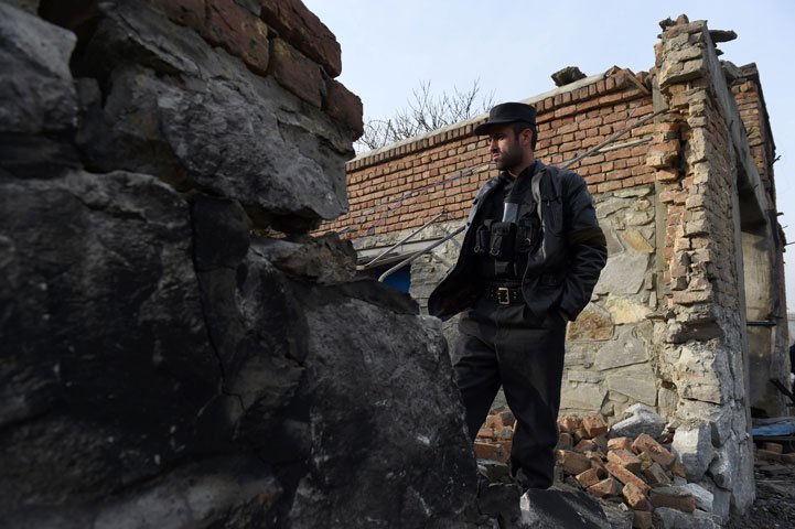 an afghan security official inspects the wreckage of an entrance gate the day after a suicide car bomb attack at a french restaurant  le jardin in kabul on january 2 2016 photo afp