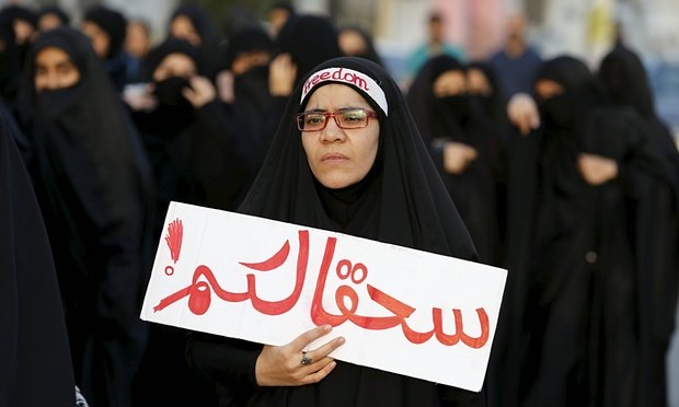 protester holds a banner saying to hell with you as she takes part in a protest against the execution of saudi shia cleric nimr al nimr by saudi authorities in the village of sanabis photo reuters