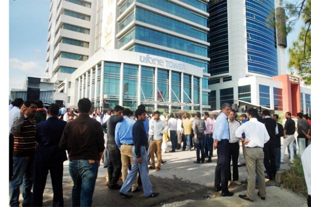 office workers seen outside a high rise building after 5 8 magnitude earthquake jolted the areas of pakistan and afghanistan photo online office workers seen outside a high rise building after 5 8 magnitude earthquake jolted the areas of pakistan and afghanistan photo online