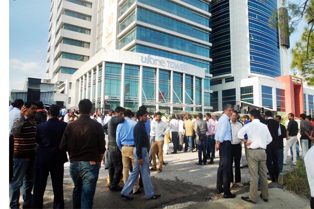 office workers seen outside a high rise building after 5 8 magnitude earthquake jolted the areas of pakistan and afghanistan photo online