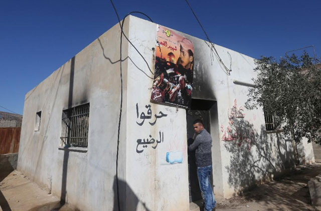 a palestinian man stands on december 4 2015 at the entrance of the burnt out home of saad dawabsha who was killed alongside his toddler and wife when their house was firebombed by jewish extremists on july 31 2015 in the west bank village of duma photo afp