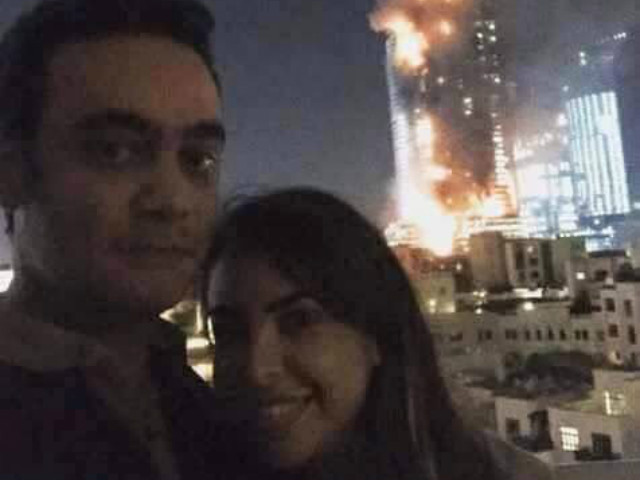 the couple posed with the burning hotel in dubai in the background on new year 039 s eve photo twitter