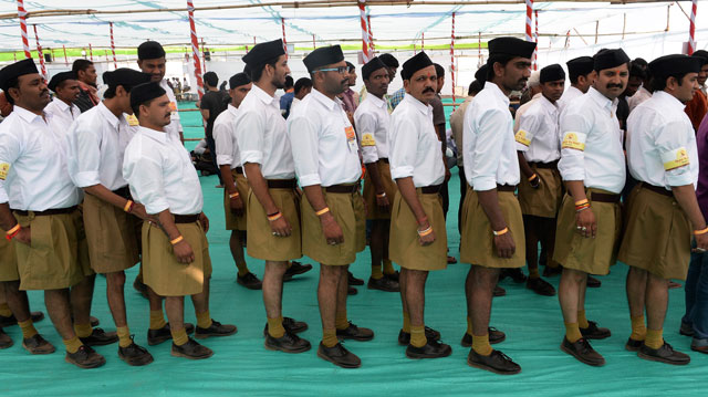 volunteers from indian right wing organisation rashtriya swayamsevak sangh rss queue as they arrive for a rally in pune on january 3 2016 photo afp