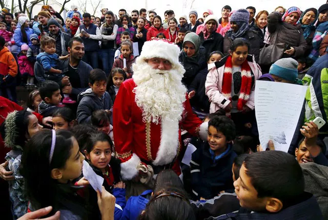 migrant children surround a volunteer dressed as santa claus during a christmas gathering organised by local relief organisation at the refugee camp in hanau germany photo reuters migrant children surround a volunteer dressed as santa claus during a christmas gathering organised by local relief organisation at the refugee camp in hanau germany photo reuters