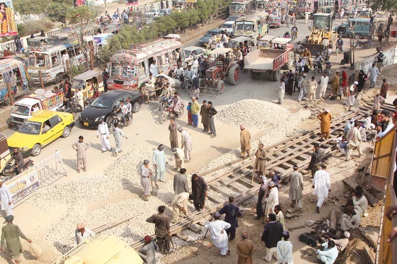 repair work on the railway track near natha khan bridge caused a massive traffic jam near drigh road on saturday photo aysha saleem express