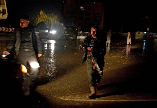 afghan security personnel check a vehicle along a street after an unknown number of assailants mounted the attack from a building close to the indian consulate in mazar i sharif prompting afghan forces to cordon off the area late on january 3 2016 photo afp