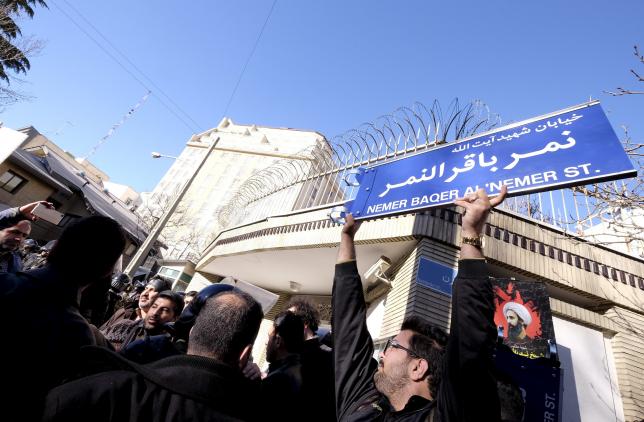 an iranian protester holds up a street sign with the name of shi 039 ite cleric sheikh nimr al nimr during a demonstration against the execution of nimr in saudi arabia outside the saudi arabian embassy in tehran january 3 2016 photo reuters