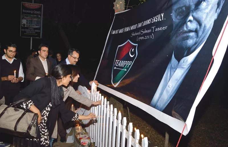 participants light candles under a banner of salman taseer at kohsar market in islamabad photo mudassar raja express participants light candles under a banner of salman taseer at kohsar market in islamabad photo mudassar raja express
