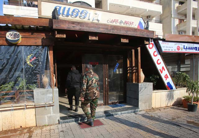 customers enter a cafe advertising russian products in the syrian coastal city of latakia on december 19 2015 many shops and restaurants are hoping to attract the russian soldiers who have arrived in latakia since moscow began a military intervention in syria in late september photo afp customers enter a cafe advertising russian products in the syrian coastal city of latakia on december 19 2015 many shops and restaurants are hoping to attract the russian soldiers who have arrived in latakia since moscow began a military intervention in syria in late september photo afp