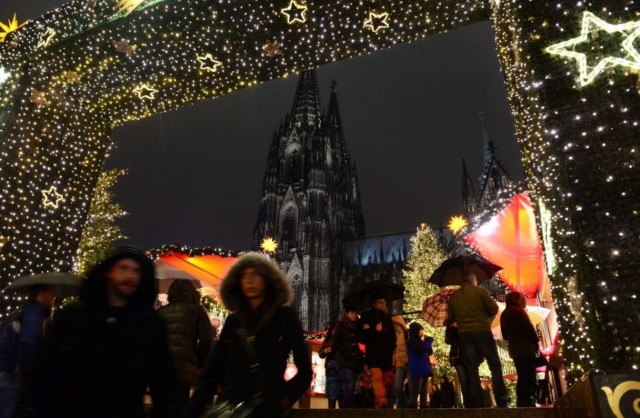 people walk through the entrance of a market in cologne germany during new year 039 s eve photo afp people walk through the entrance of a market in cologne germany during new year 039 s eve photo afp