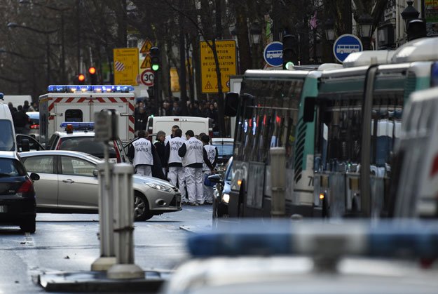 rescue workers are seen at the boulevard de barbes in the north of paris on january 7 2016 after police shot a man dead as he was trying to enter a police station in the rue de la goutte d 039 or photo afp