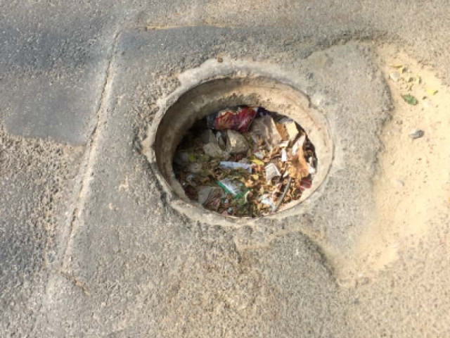 an open manhole filled with junk on saba avenue dha photo express an open manhole filled with junk on saba avenue dha photo express