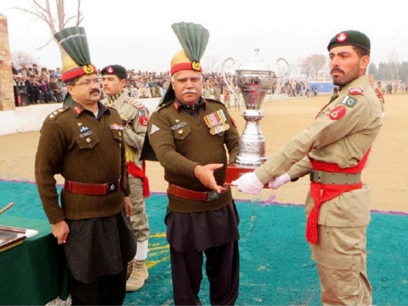 brigadier ziaul islam presents a trophy to a recruit during a passing out parade of bajaur scouts in khar photo express