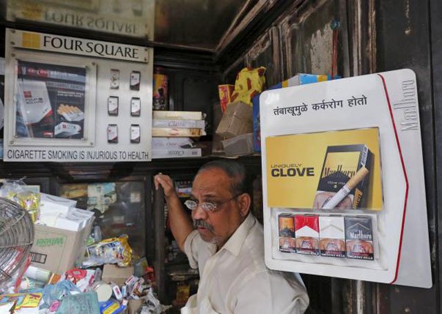 a shopkeeper selling cigarettes waits in his store at a market in mumbai india on january 6 2016 photo reuters