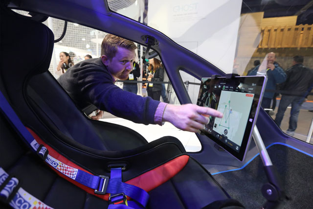 an exhibitor touches the screen of the newly launched ehang 184 aav autonomous aerial vehicle that can autonomously fly a human passenger programmed with an app at the ces 2016 consumer electronics show in las vegas nevada on january 7 2016 photo afp