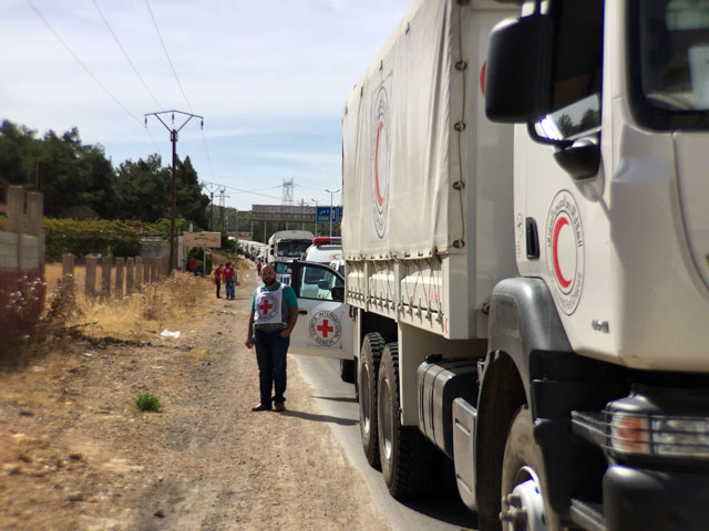 a file handout picture released by the international committee of the red cross icrc shows a relief convoy carrying medical items having a stopover 10 km from syrian cities of zabadani and madaya some 50 km northwest of damascus on october 18 2015 photo afp