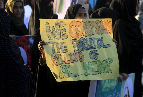 a shia muslim woman holds a sign for cleric nimr al nimr who was executed along with others in saudi arabia during a protest rally in islamabad pakistan on january 8 2016 photo reuters