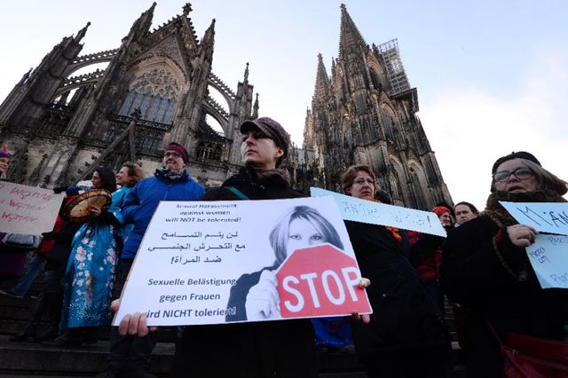 a woman holds a sign reading quot sexual harassment against women will not be tolerated quot while taking part in a demonstration in cologne western germany on january 9 2015 photo afp