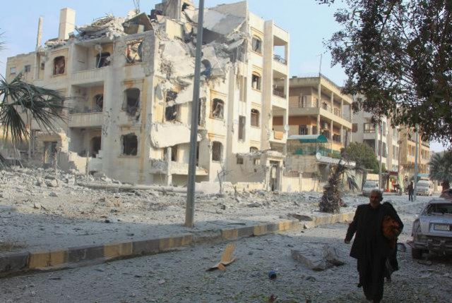 a man walks past damaged buildings after what activists said were airstrikes carried out by the russian air force in idlib city syria december 20 2015 photo reuters a man walks past damaged buildings after what activists said were airstrikes carried out by the russian air force in idlib city syria december 20 2015 photo reuters