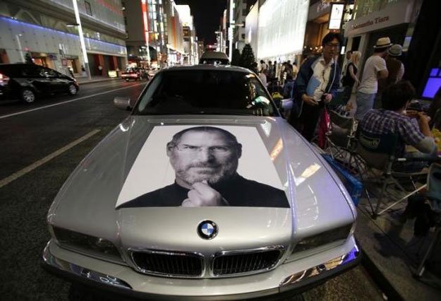 a portrait of apple 039 s co founder steve jobs is seen on a bmw car in tokyo 039 s ginza shopping district photo reuters