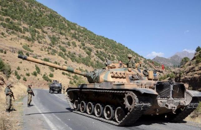 turkish soldiers in a tank and an armored vehicle patrol on the road to the town of beytussebab in the southeastern sirnak province turkey september 28 2015 photo reuters