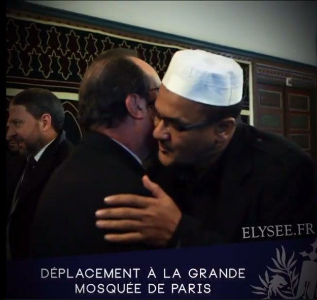 screen grab showing hollande hugging a muslim at paris main mosque