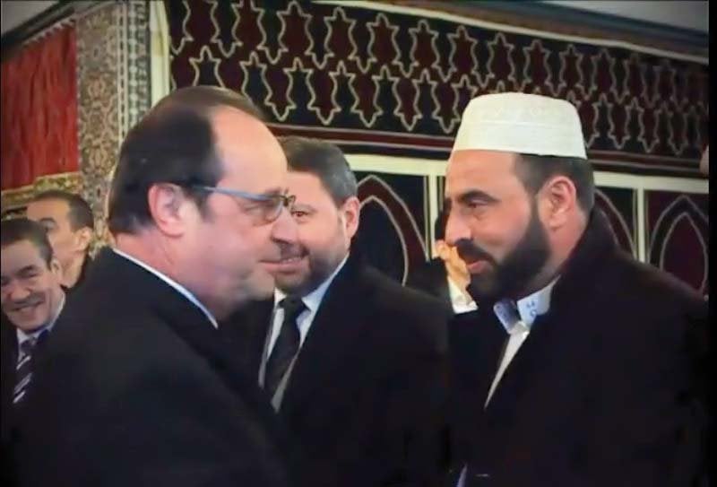 a screen grab from a video released by the french presidency shows hollande being greeted by religious leaders at the paris mosque photo express