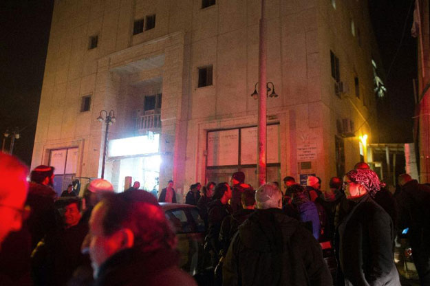 firemen arrive at the building in jerusalem that houses israeli rights group b 039 tselem office after a fire broke out overnight on january 10 2016 photo afp