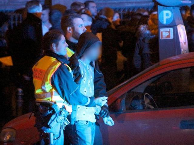 picture taken on january 1 2016 shows police arresting a man as people gather in front of the main railway station in cologne western germany photo afp