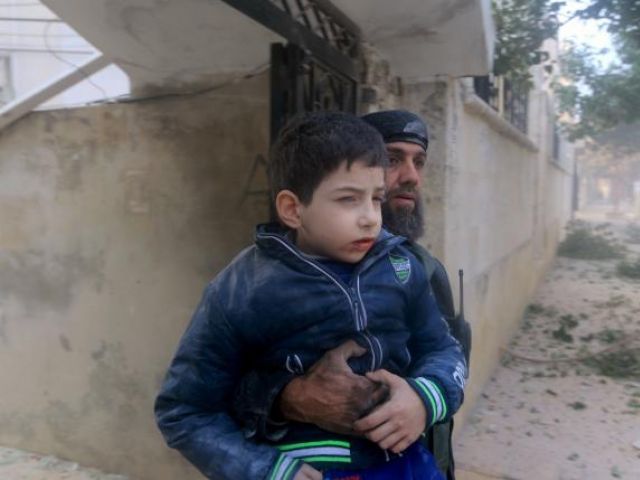 a rescue worker holds an injured boy after what activists said were airstrikes carried out by the russian air force in idlib city syria december 20 2015 photo reuters