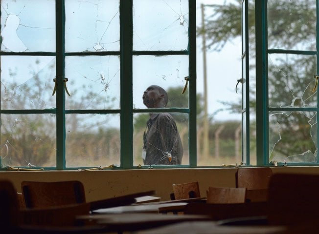 a man walks outside a lecture hall with bullet shattered window panes in garissa university on january 11 2016 photo afp