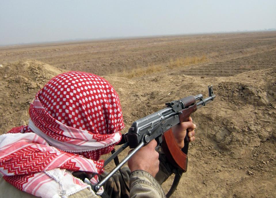 an anti qaeda 039 awakening 039 group fighter scans an area outside a village on the southern outskirts of the diyala provincial capital baquba northeast of baghdad on january 28 2008 photo afp