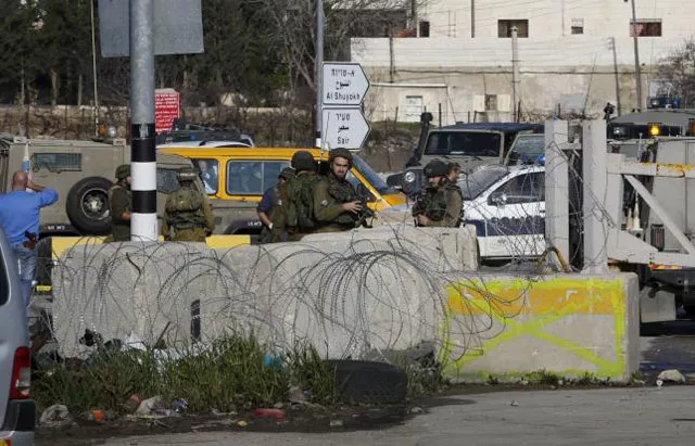 israeli soldiers stand guard near the scene where israeli military said a palestinian who tried to stab a soldier was shot dead by israeli troops in the west bank city of hebron january 12 2016 photo reuters israeli soldiers stand guard near the scene where israeli military said a palestinian who tried to stab a soldier was shot dead by israeli troops in the west bank city of hebron january 12 2016 photo reuters