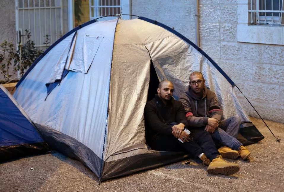 samer abu eisheh l and hijazi abu sbeih palestinians from jerusalem installed tents at the international committee of the red cross icrc in the city defying a military order banning them from entering their hometown for months photo afp samer abu eisheh l and hijazi abu sbeih palestinians from jerusalem installed tents at the international committee of the red cross icrc in the city defying a military order banning them from entering their hometown for months photo afp
