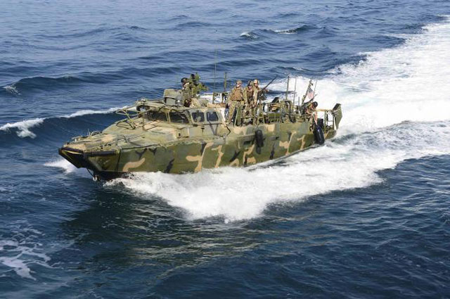 a riverine patrol boat from costal riverine squadron 2 escorts the guided missile cruiser uss bunker hill cg 52 while in the arabia gulf in this november 15 2014 handout photo provided by the u s navy january 12 2016 photo reuters