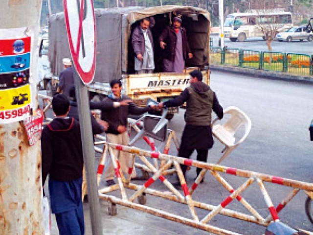 a vendor tries to stop cda officials from confiscating couple of plastic chairs from his roadside stall photo vaqas asghar express a vendor tries to stop cda officials from confiscating couple of plastic chairs from his roadside stall photo vaqas asghar express