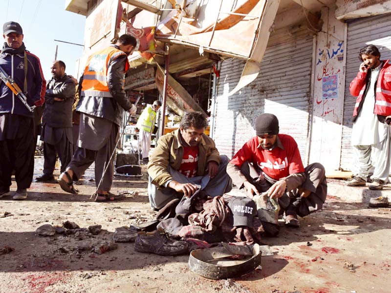 rescuers gather the belongings of the victims at the blast site photo afp