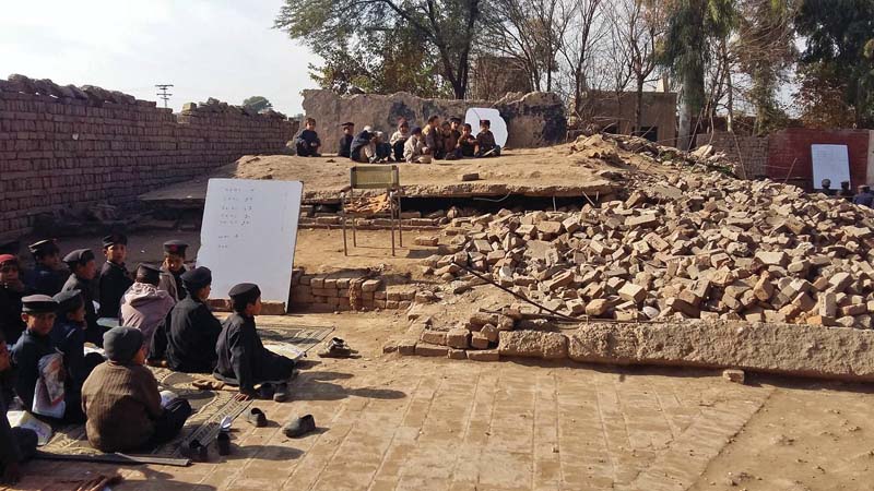 students sit on the floor of gps mashokhel that was blown up by militants photo express