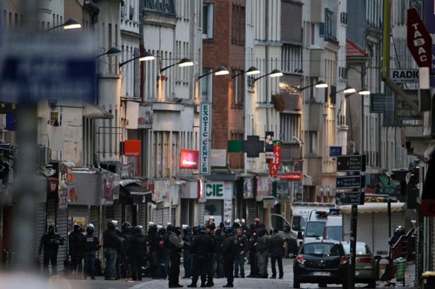 police officers gather in the northern paris suburb of saint denis city centre on november 18 2015 as french police special forces raid an apartment hunting those behind the attacks that claimed 130 lives photo afp